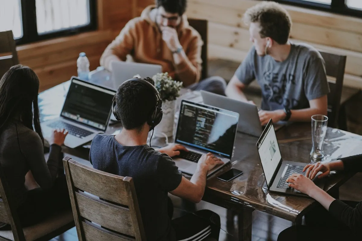 Software development team collaborating on deployment pipeline code