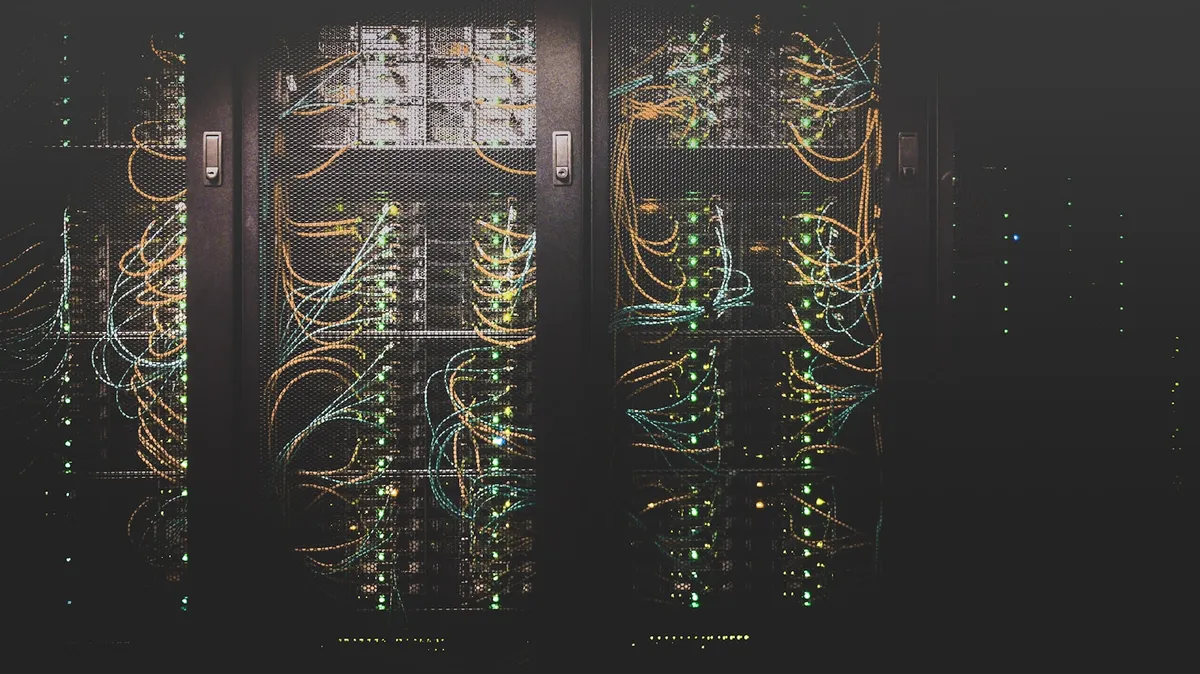 Rows of network cables in a datacenter, the shared fabric that cloud runs on